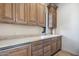 Well-appointed kitchenette with wood cabinets and granite countertops at 26872 N 102Nd St, Scottsdale, AZ 85262