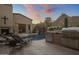 Outdoor kitchen area with a built-in grill and seating at 26872 N 102Nd St, Scottsdale, AZ 85262