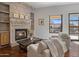 Cozy sitting area with fireplace and built-in shelving at 26872 N 102Nd St, Scottsdale, AZ 85262