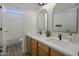 Shared bathroom with double vanity and arched mirrors at 4132 E Santa Fe Ln, Gilbert, AZ 85297