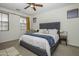 Main bedroom with gray upholstered bed and a sitting chair at 4132 E Santa Fe Ln, Gilbert, AZ 85297