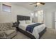 Main bedroom with gray upholstered bed and sitting chair at 4132 E Santa Fe Ln, Gilbert, AZ 85297