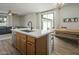 Modern kitchen with island, stainless steel appliances, and wood cabinets at 4132 E Santa Fe Ln, Gilbert, AZ 85297