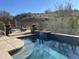 Inviting backyard oasis featuring a sparkling pool, spa, and ample patio space at 4742 S Primrose Dr, Gold Canyon, AZ 85118