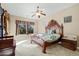 Main bedroom with ornate headboard and large windows at 4742 S Primrose Dr, Gold Canyon, AZ 85118