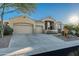 Tan two-story house with a three car garage and nicely landscaped yard at 4742 S Primrose Dr, Gold Canyon, AZ 85118