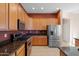 Modern kitchen with stainless steel appliances and dark wood cabinets at 4742 S Primrose Dr, Gold Canyon, AZ 85118