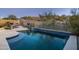 Inviting swimming pool with a spa and a beautiful desert landscape at 4742 S Primrose Dr, Gold Canyon, AZ 85118