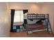 Cozy bedroom with a bunk bed, window, and storage at 4913 W Pedro Ln, Laveen, AZ 85339