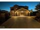 Two-story house with a three-car garage, illuminated at night at 4913 W Pedro Ln, Laveen, AZ 85339