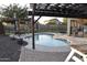 Inviting kidney-shaped pool with pergola and patio furniture at 4913 W Pedro Ln, Laveen, AZ 85339