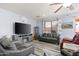 Living room features gray sofas, a fireplace, and wood-look floors at 6131 S Eagle Pass Rd, Gold Canyon, AZ 85118