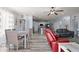 Open living room with a red recliner, gray sofa, and view of kitchen and dining area at 6131 S Eagle Pass Rd, Gold Canyon, AZ 85118