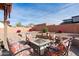 Cozy patio with fire pit and floral patterned chairs at 6131 S Eagle Pass Rd, Gold Canyon, AZ 85118