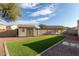 Landscaped backyard with artificial turf and storage shed at 702 E Nancy Ave, San Tan Valley, AZ 85140