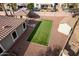 Artificial turf backyard with shed and partial house view at 702 E Nancy Ave, San Tan Valley, AZ 85140