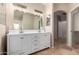 Double vanity bathroom with white cabinets and large mirror at 702 E Nancy Ave, San Tan Valley, AZ 85140