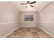 Bedroom with window, ceiling fan and tile flooring at 702 E Nancy Ave, San Tan Valley, AZ 85140