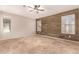 Bedroom with wood accent wall and tile floors at 702 E Nancy Ave, San Tan Valley, AZ 85140