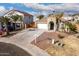 Single-story home with a two-car garage, driveway, and palm trees at 702 E Nancy Ave, San Tan Valley, AZ 85140