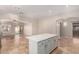 Kitchen island with white cabinets and quartz counters at 702 E Nancy Ave, San Tan Valley, AZ 85140