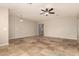 Spacious living room with tile floors and ceiling fan at 702 E Nancy Ave, San Tan Valley, AZ 85140