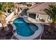 Kidney-shaped pool with surrounding landscaping and patio at 702 E Nancy Ave, San Tan Valley, AZ 85140