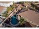 Aerial view of a kidney-shaped pool and patio area at 702 E Nancy Ave, San Tan Valley, AZ 85140