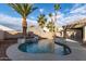 Relaxing kidney-shaped pool with waterfall feature and spacious patio at 702 E Nancy Ave, San Tan Valley, AZ 85140