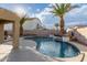 Stunning pool with a waterfall feature and a large patio area at 702 E Nancy Ave, San Tan Valley, AZ 85140