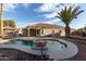 Inviting kidney shaped pool with a stone fountain in backyard setting at 702 E Nancy Ave, San Tan Valley, AZ 85140