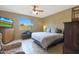 Spacious bedroom with large window, ceiling fan, and ample closet space at 10051 S 184Th Dr, Goodyear, AZ 85338