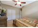 Bedroom with double closet and ceiling fan at 10051 S 184Th Dr, Goodyear, AZ 85338