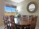 Formal dining area with a wood table and chairs, offering a view to the kitchen at 10051 S 184Th Dr, Goodyear, AZ 85338