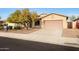 Single-story house with a two-car garage and desert landscaping at 10051 S 184Th Dr, Goodyear, AZ 85338