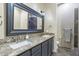 Bathroom with double vanity, granite countertop, and large mirror at 13032 N 19Th St, Phoenix, AZ 85022