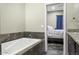 Bathroom with soaking tub and view of bedroom at 13032 N 19Th St, Phoenix, AZ 85022