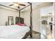 Bedroom with four-poster bed, view into adjacent living space at 13032 N 19Th St, Phoenix, AZ 85022