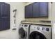 Laundry room with washer, dryer, granite countertop, and dark cabinets at 13032 N 19Th St, Phoenix, AZ 85022