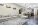 Open living area with sectional sofa, kitchen island, and modern light fixtures at 13032 N 19Th St, Phoenix, AZ 85022