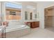 Spa-like bathroom with soaking tub and walk-in shower at 1646 W Laurel Greens Dr, Phoenix, AZ 85086