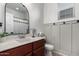 Bathroom with wood vanity, updated fixtures, and gray walls at 24758 W Huntington Dr, Buckeye, AZ 85326