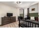 bedroom with dark wood dresser, tv, and twin bed at 24758 W Huntington Dr, Buckeye, AZ 85326