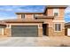 Two-story house with stone accents and a two-car garage at 24758 W Huntington Dr, Buckeye, AZ 85326