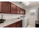 Laundry room with washer, dryer, and cabinets at 24758 W Huntington Dr, Buckeye, AZ 85326