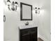 Bathroom with vanity, framed mirror, and elegant light fixtures at 2549 E Cherrywood Pl, Chandler, AZ 85249