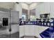 Kitchen features white cabinets, blue tile counters, and stainless steel appliances at 2549 E Cherrywood Pl, Chandler, AZ 85249