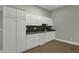 Well-equipped kitchenette featuring white cabinets and modern countertops at 2549 E Cherrywood Pl, Chandler, AZ 85249