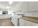 Laundry room with white cabinets and modern appliances at 2549 E Cherrywood Pl, Chandler, AZ 85249