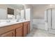 Bathroom with double vanity, soaking tub, and shower at 27227 N 171St Dr, Surprise, AZ 85387